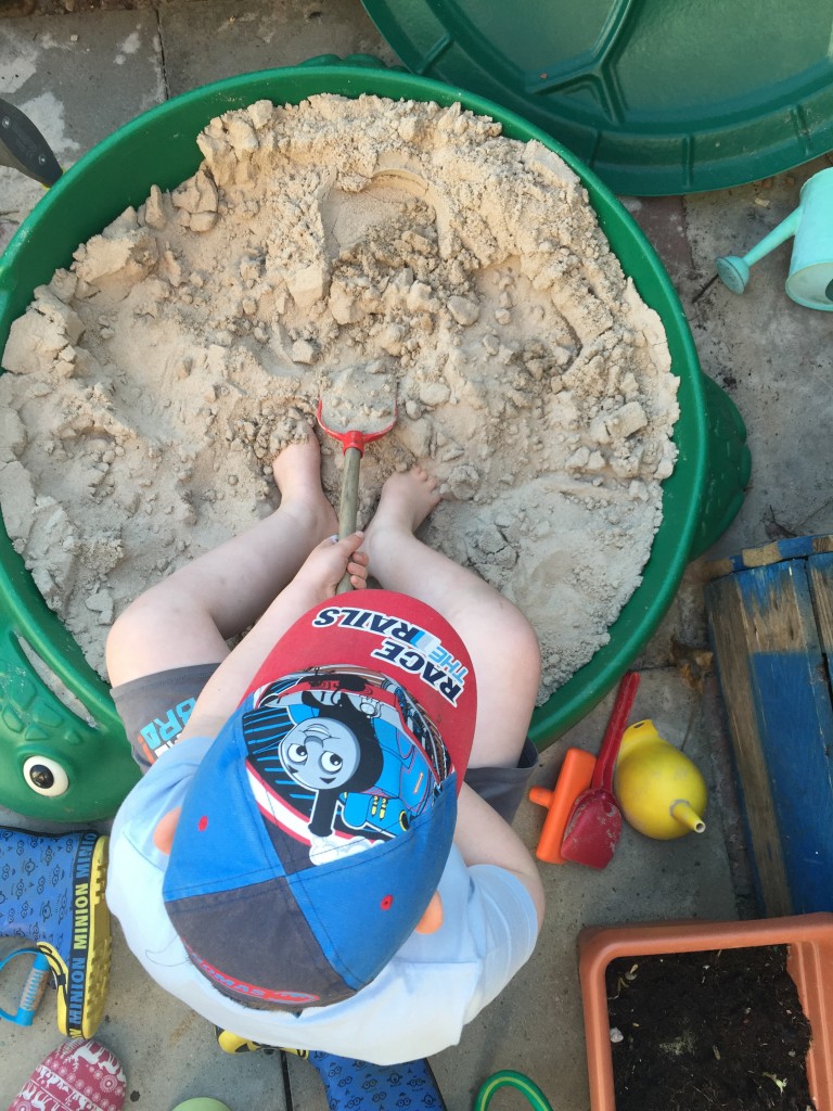 playing in the sand pit